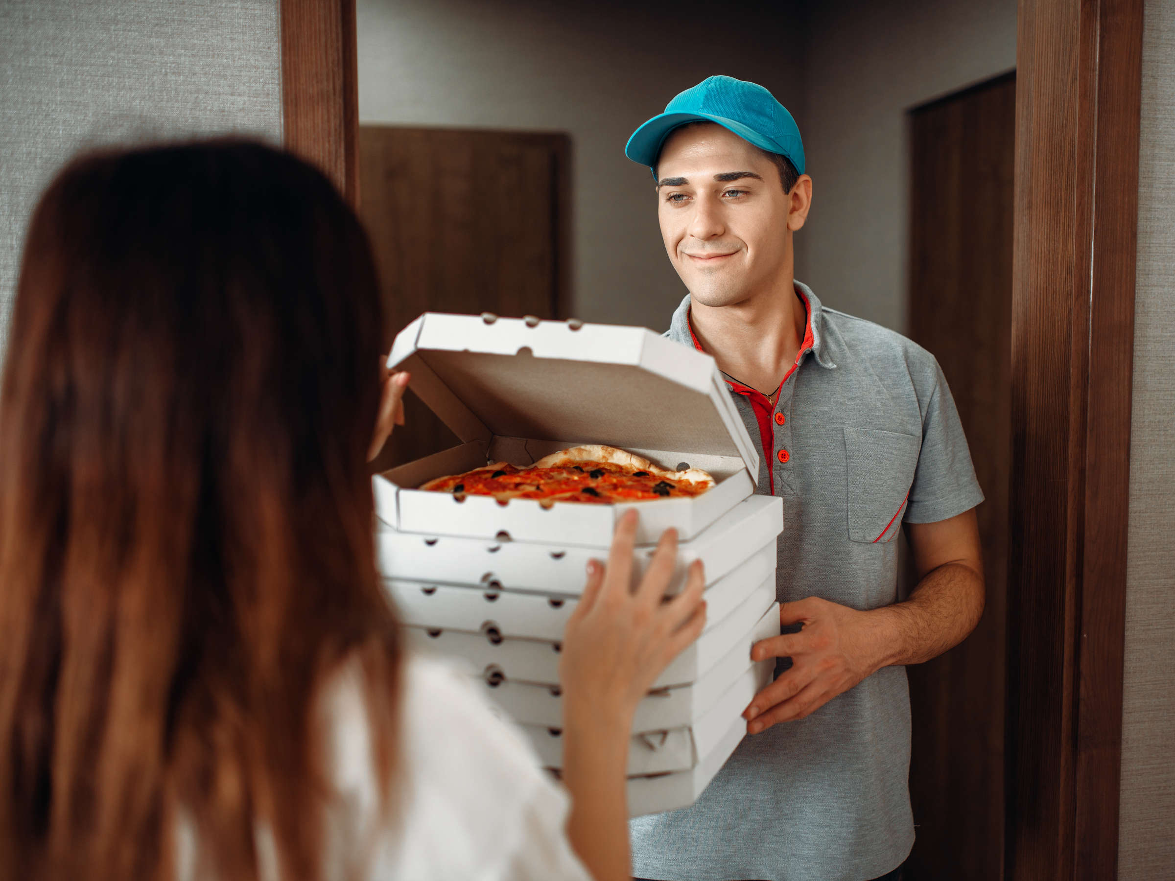 Delivery,Man,Shows,Pizza,To,Customer,At,The,Door