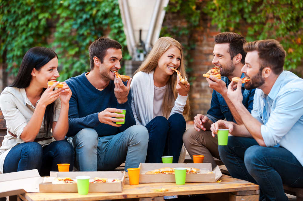 Group of people eating pizza